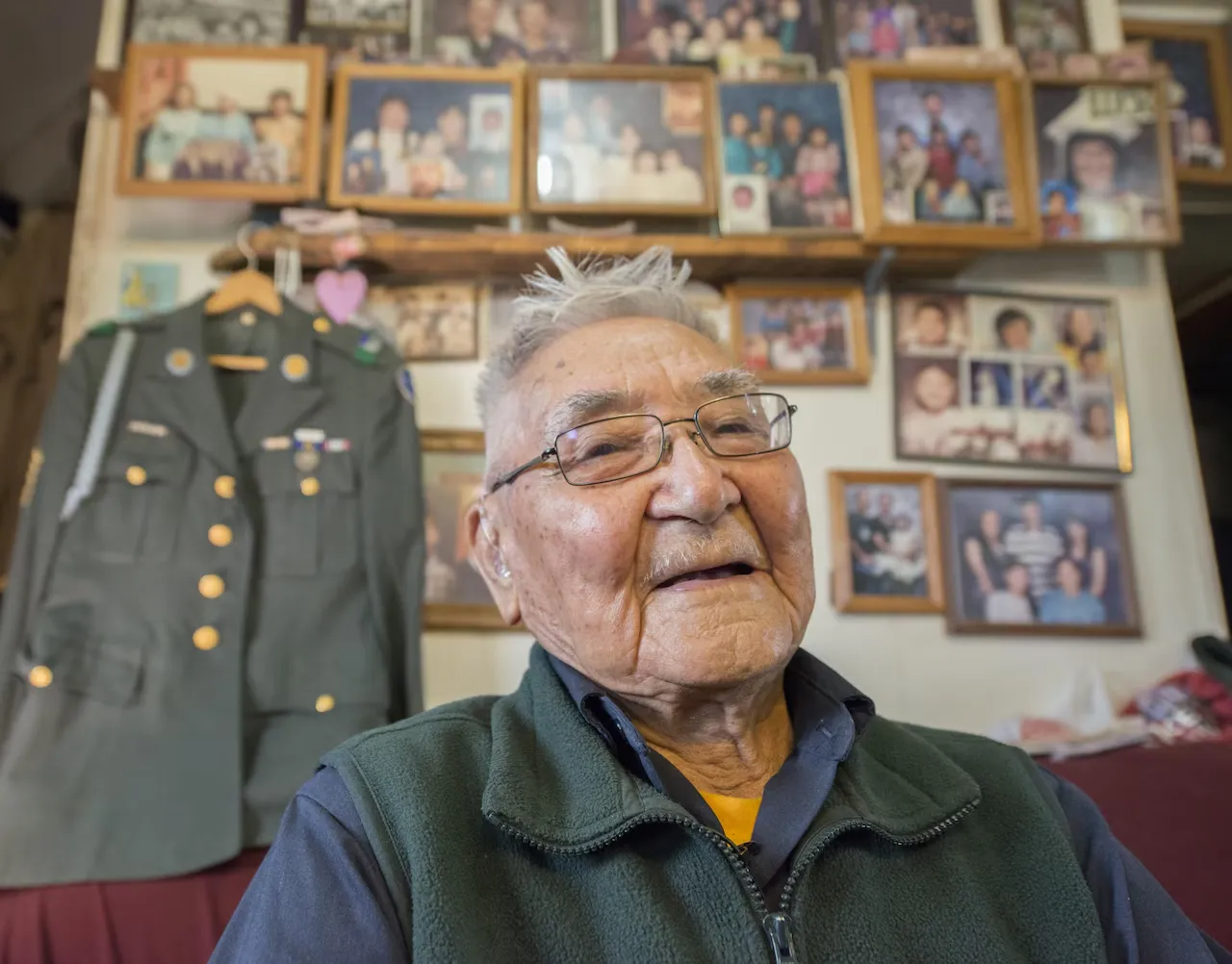 On the photo Retired Sgt. 1st Class Sam Jackson, who served in the Alaska Territorial Guard during World War II, poses for a photo inside his home in Kwethluk, Alaska, September 23, 2017
